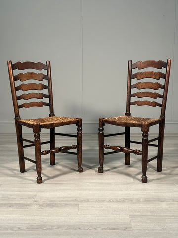 A Pair Of Antique Elm Rush Ladderback Chairs